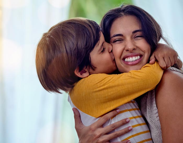 son kissing mother on cheek